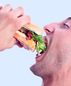 Man Stuffing His Face with a Burger