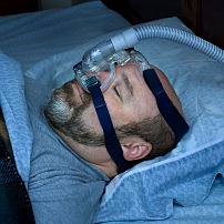 Sleeping Man with CPAP Mask on